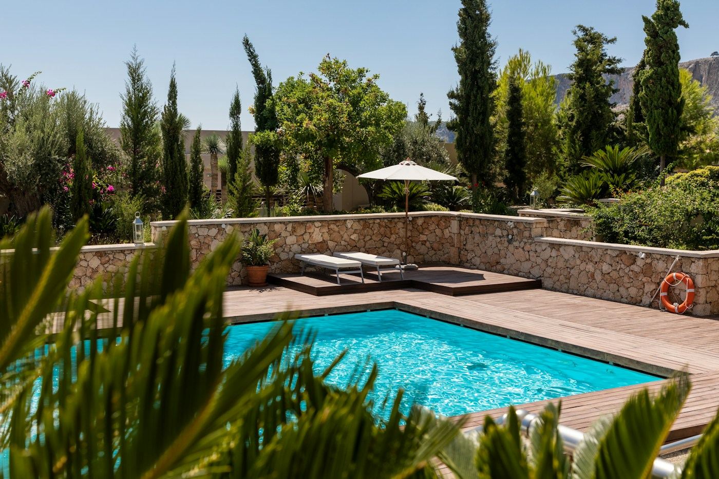 An inviting pool surrounded by Mediterranean greenery